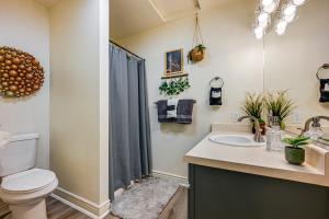 a bathroom with a toilet and a sink at Deck and Mountain Views Cedar City Family Home! in Cedar City +25 photos
