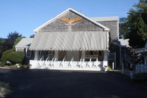a building with a bunch of chairs in front of it at Dennis Village Adorable Studio Cottage 5951 in Dennis