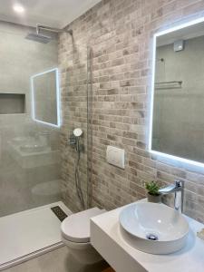 a bathroom with a sink and a toilet and a shower at Villa Mediterranea in Murter