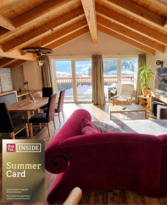 a living room with a purple couch and a table at Rooftop by Northsouth Apartments in Sölden