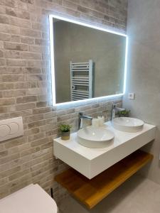 a bathroom with two sinks and a large mirror at Villa Mediterranea in Murter +50 photos