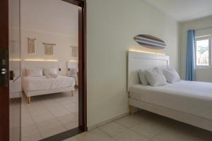 Ein Bett oder Betten in einem Zimmer der Unterkunft MERAKII SEAVIEW ESCAPE CURACAO