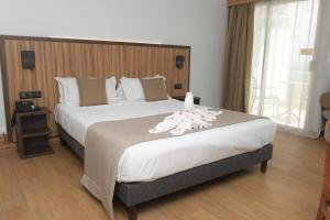 Postel nebo postele na pokoji v ubytování Carayou Hotel & SPA