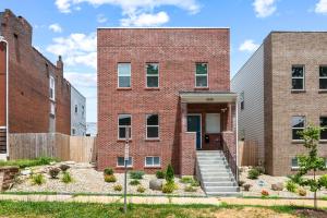 a brick building with a staircase in front of it at 3325 Bright Urban Comfort in Tower Grove