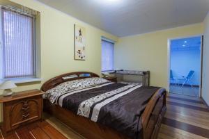 a bedroom with a bed and a table and a window at Raigardo in Druskininkai