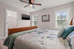 a bedroom with a bed and a ceiling fan at Tranquility - Brand new home in quiet location! in Deep Hole