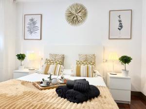 a bedroom with a large bed with a tray on it at Castro Holidays - Céntrico Piscina Urbanización Garaje Gratis in Castro-Urdiales