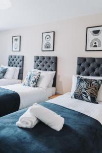 マンチェスターにある2 Bed 2 Bath Apartment Close to City Ctre Sleeps 5 -Free Parkingのベッド2台(タオル付)が備わる客室です。