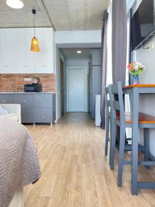 a kitchen and living room with a table and a dining room at New Gudauri Twins in Gudauri