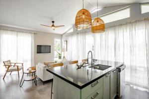 a kitchen with a sink and a living room at Beautiful & Boho 2BR Villa 14 at Playa Venao in Playa Venao +44 photos