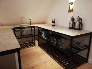 a kitchen with a counter with wine glasses on it at Villa Ferie og Overnatning in Svendborg +16 photos
