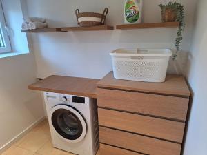 a laundry room with a washing machine on a counter at Cozy and perfectly located apartment in Rixensart
