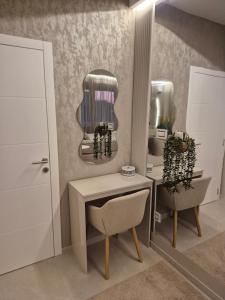 a dressing room with a table and a mirror at Cappuccino LUX in Novi Sad +16 photos