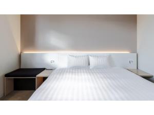 a bedroom with a white bed and a desk at The OneFive Sendai - Vacation STAY 35252v in Sendai