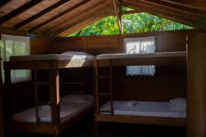 two bunk beds in a room with a window at Casa Cielito in Nuquí +57 photos