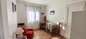 a living room with a red couch and a table at Flores del Alma PSC in Puerto Santa Cruz