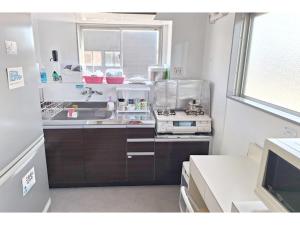 a small kitchen with a sink and a stove at Business Hotel B,loom - Vacation STAY 38188v in Tanabe