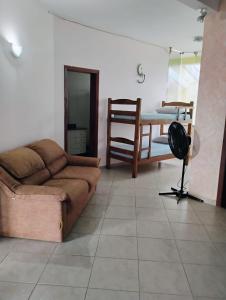 a living room with a couch and a table at Casa da praia pousada in Peruíbe