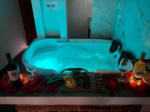 a bath tub with a tray of food and wine glasses at Hotel Boutique Cenit in Villa de Leyva +83 photos