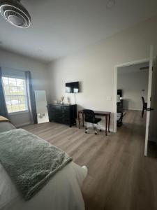 a bedroom with a bed and a desk and a table at Richland Villa in Vidalia +2 photos