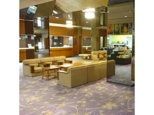 a lobby with couches and tables in a building at Hotel Tetora Resort Tsuruoka - Vacation STAY 39431v in Tsuruoka