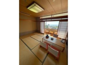 a room with a table and chairs and a window at Hotel Tetora Resort Tsuruoka - Vacation STAY 39373v in Tsuruoka +13 photos