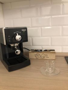 a coffee maker sitting on a counter next to a box at Le Antiche Alcove in Terrasini +79 photos