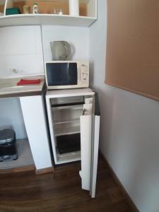 a small kitchen with a microwave on a counter at El Estudio in Villa Marini
