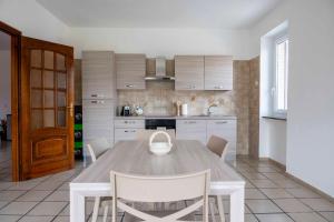 a kitchen with a table and chairs in a room at Casa vacanza Nada in Dogliani