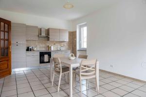 a kitchen with a table and chairs in a room at Casa vacanza Nada in Dogliani +15 photos