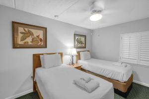 a hotel room with two beds and a window at Ocean View at Island Club in Hilton Head Island +32 photos