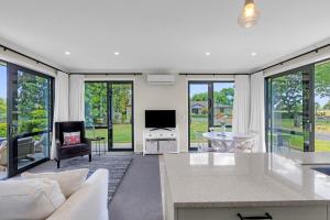 a living room with a couch and a table at Peter's Puketaha Homestay in Ruakura Junction