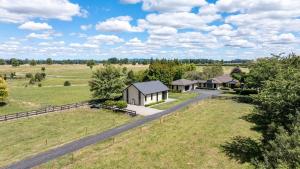 an aerial view of a house in the middle of a field at Peter's Puketaha Homestay in Ruakura Junction