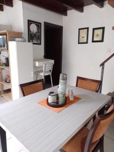 a dining room table with a white table cloth and chairs at El Refugio al Norte del Fin del Mundo in Río Grande