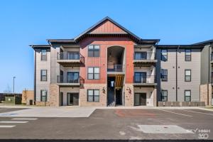 an empty parking lot in front of an apartment building at Relax In Style Cozy 1br W Pool, Gym & Free "p" in Rogers
