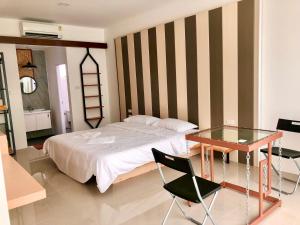 a bedroom with a bed and a glass table at Pai Casita walking street in Pai