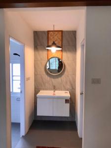 a bathroom with a sink and a mirror at Pai Casita walking street in Pai