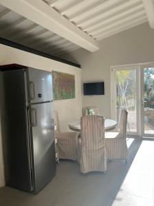 a kitchen with a refrigerator and a table with chairs at Joy home in Antella