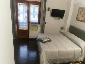 a bedroom with a bed and a flat screen tv at Casa vacanza Pescasseroli in Pescasseroli