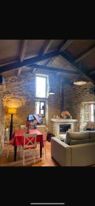 a living room with a couch and a table in it at CASA CON FINCA PRIVADA in Moaña