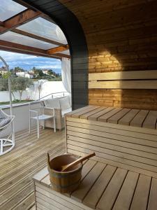 a wooden sauna with a tub on a deck at Alojamento Jasmine in São Pedro de Alva