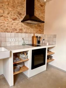 a kitchen with a sink and a stove top oven at Casa Anguila in Amposta