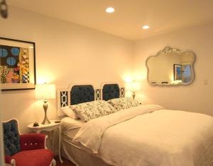 a bedroom with a bed and a mirror and a chair at Venice Beach Apartments Monthly rents in Los Angeles
