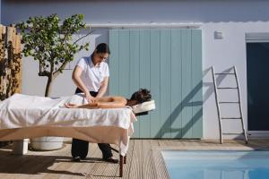a woman getting a massage in a bed at Casa Calmar in Porto Covo