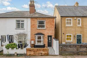 a brick house with a black door at Very Luxury home 5min walk to Hertford Town in Hertford