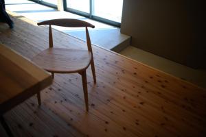 a wooden chair sitting on top of a wooden floor at JINEN hida takayama in Machikata