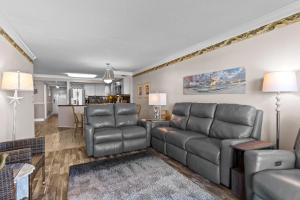 a living room with a couch and chairs at Pelican Watch #405 in Carolina Beach