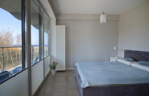Ένα ή περισσότερα κρεβάτια σε δωμάτιο στο Apartamenty Amon Darłówek Emilia Strupiechowska