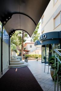 a building with an archway in front of a building at Hotel Sirolo in Sirolo