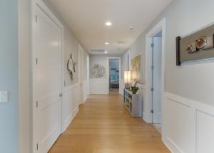 a hallway with white walls and a hard wood floor at Dare2Dream - Luxury Home at North Beach Resort & Villas in Myrtle Beach